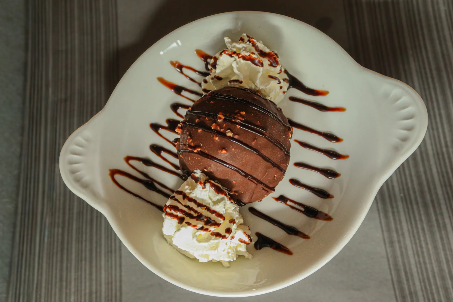 Tartufo met slagroom, van bovenaf in een schelpvormig schaaltje